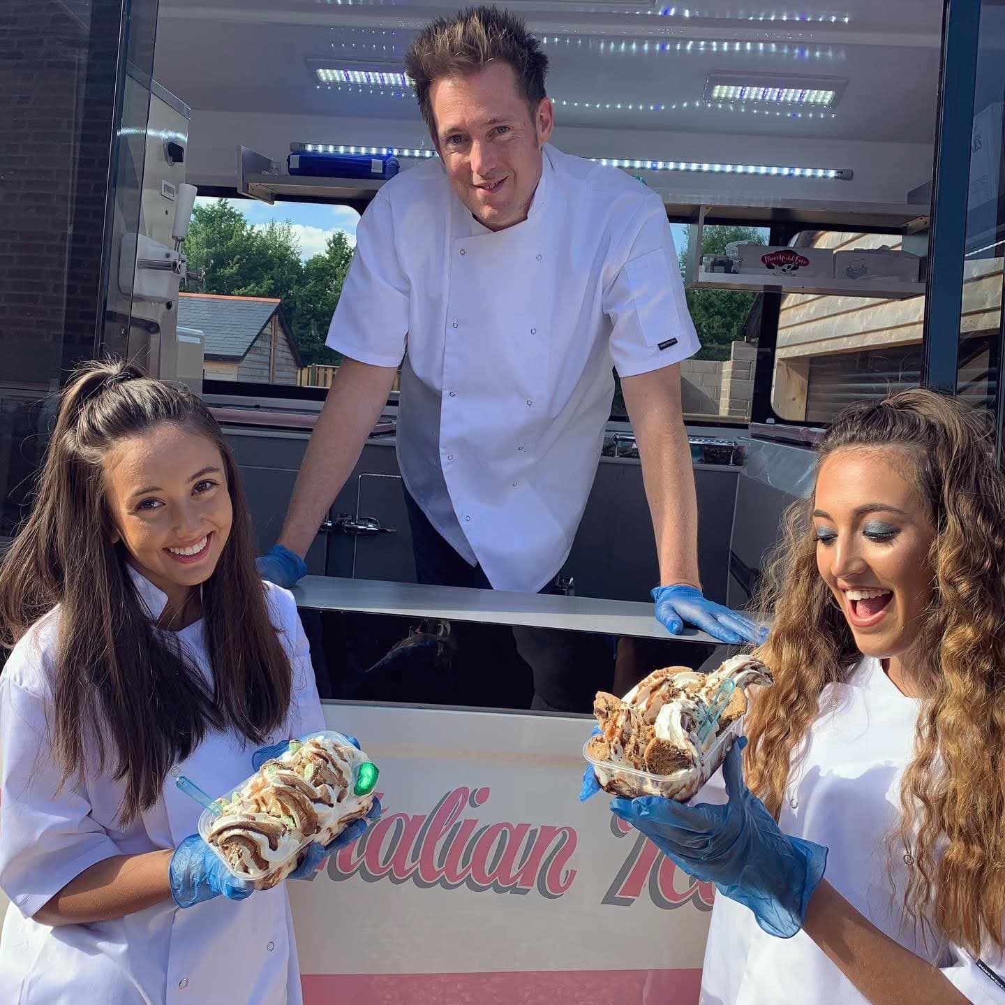 Three Hampshire Ices servers holding loaded ice cream trays at the van